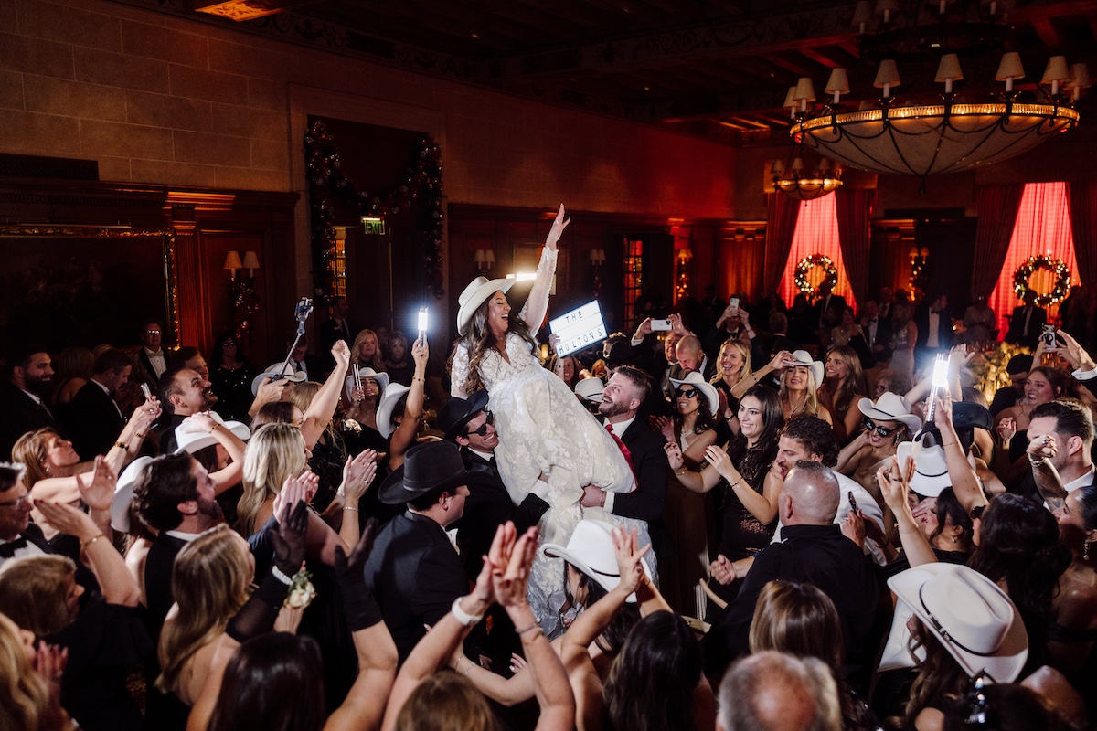 Bride and groom celebrating midnight at a New Year's Eve wedding at the Detroit Athletic Club
